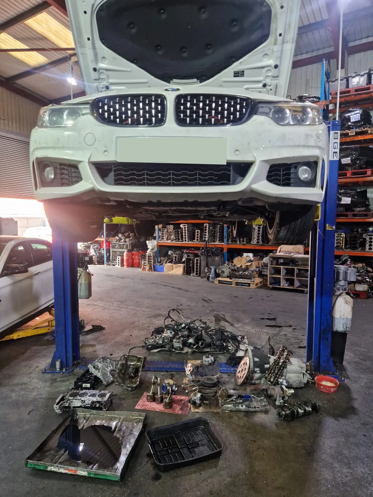 BMW 420d on lift with disassembled parts
